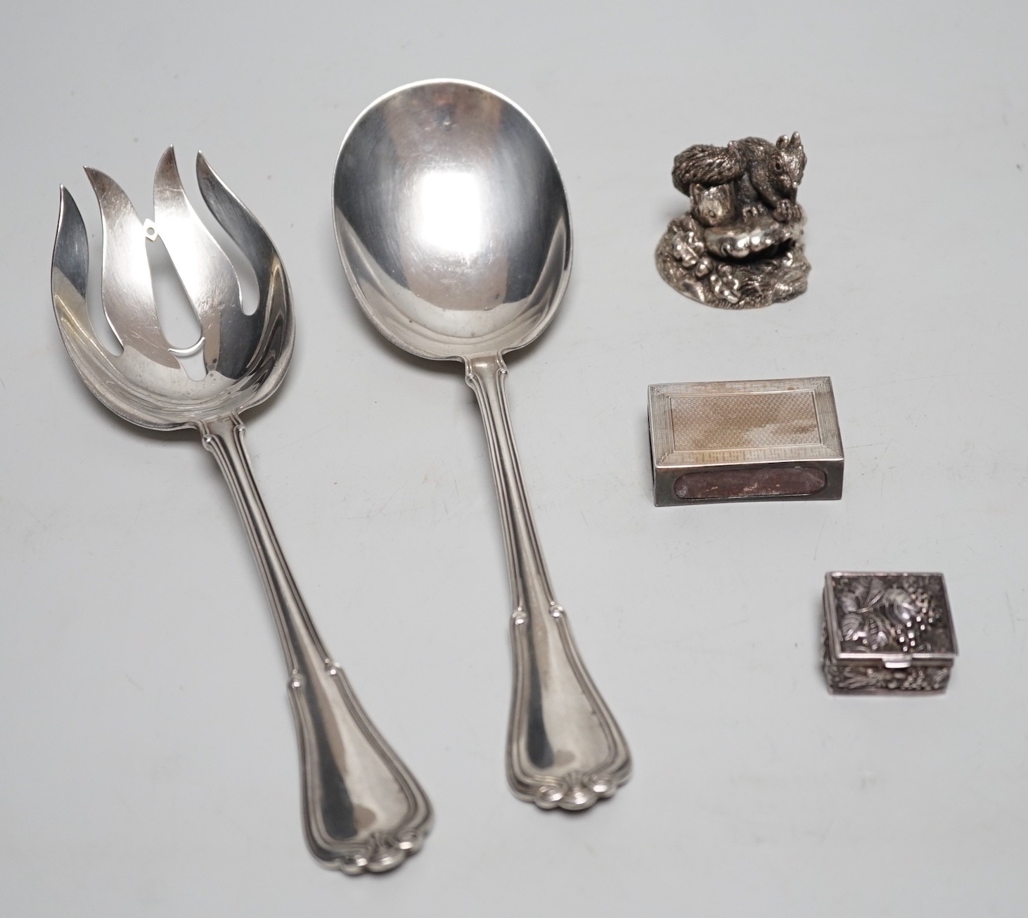 A pair of George V sterling silver salad servers, Birmingham import marks, 22cm, a modern silver pill box and match sleeve and a modern silver (filled) model squirrel.